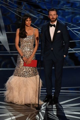 Sofia Boutella with actor Chris Evans presenting the award for Best Sound Editing 