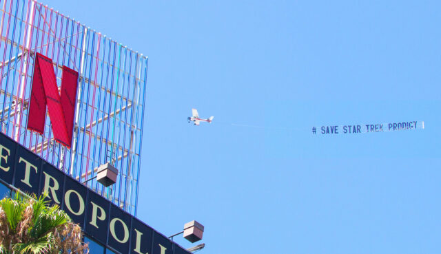 plane with save star trek prodigy banner flies over building with netflix logo 